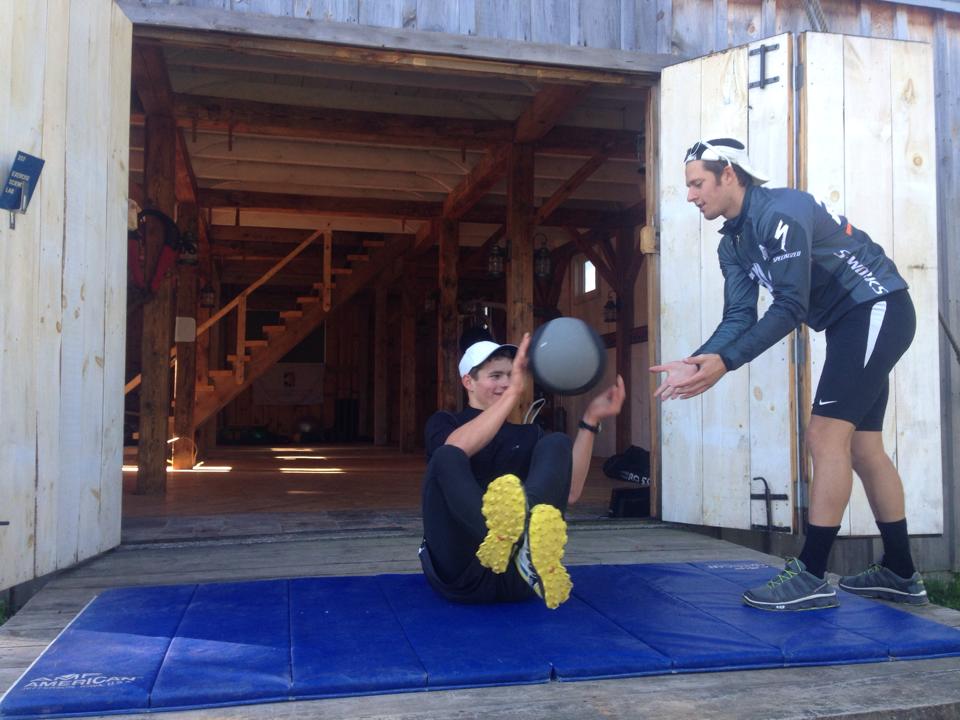 The newly appointed CXC Team Head Coach Andy Keller (r) works on strength with an athlete outside a barn near Cable, Wis. (Photo: CXC/Facebook)