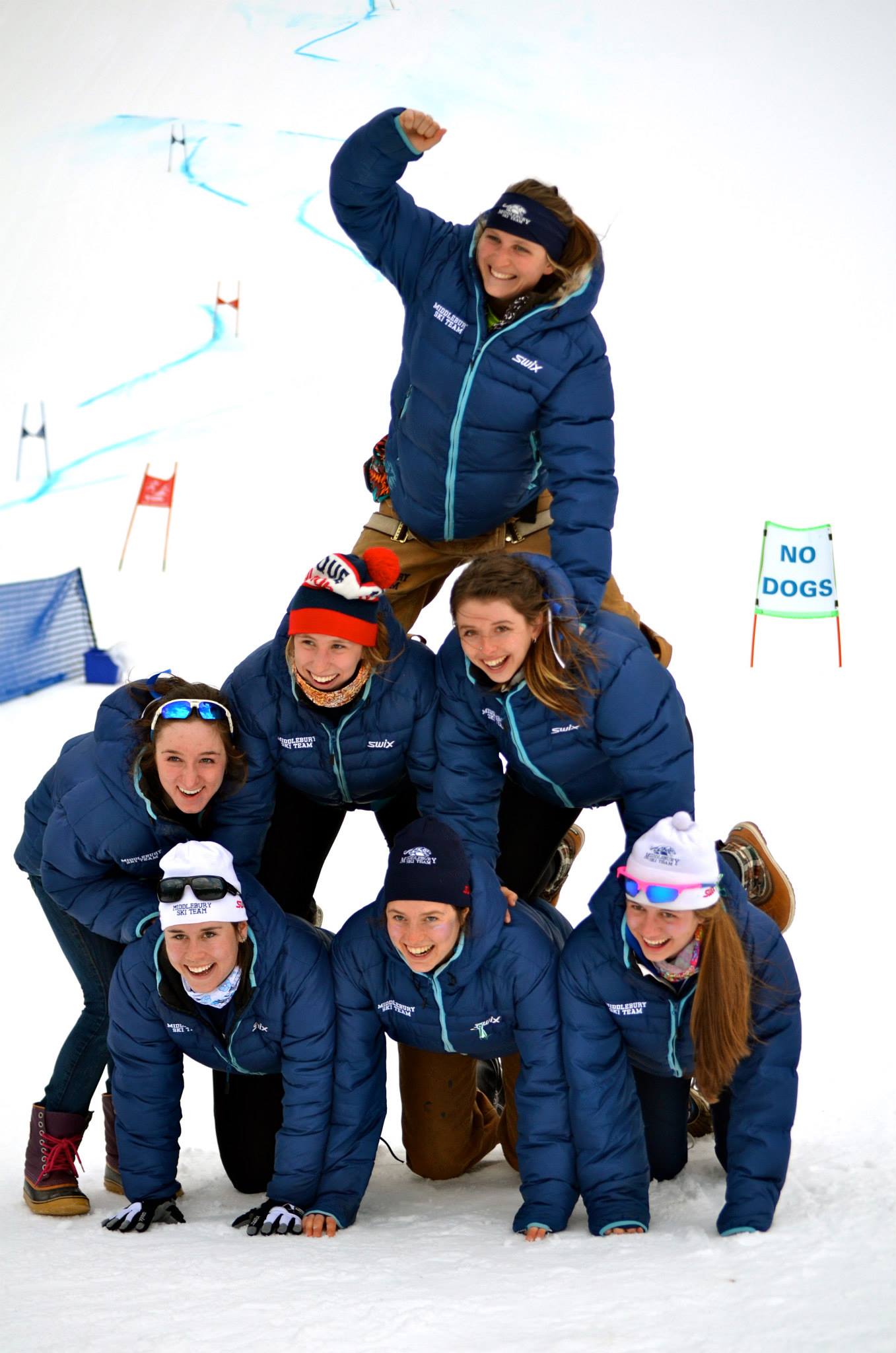 Emily Attwood celebrates her final college ski race atop a pyramid of her Middbury College teammates. (Photo: Stella Holt)