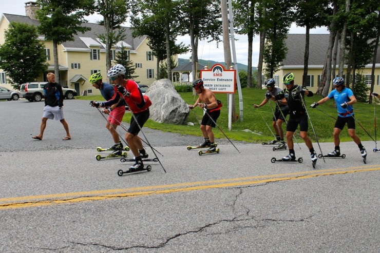 Andy Newell (l) and Alex Harvey (r) lead an over-distance rollerski past the Stratton Mountain School while Canadian coach Tor-Arne Hetland (l) checks in. 
