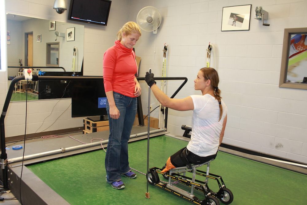 U.S. Paralympics Nordic skier Oksana Masters (r} talks to coach Eileen Carey before her first time on a treadmill on Sept. 16 at the Olympic Training Center on Sept. 16 in Lake Placid, N.Y. 