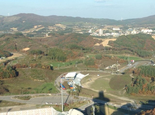 The biathlon and cross country venues at the Alpensia Nordic center for the 2018 Olympic Games in PyeongChang. The photo is taken from the top of the ski jumps. Photo: Tom Holland (CCC).