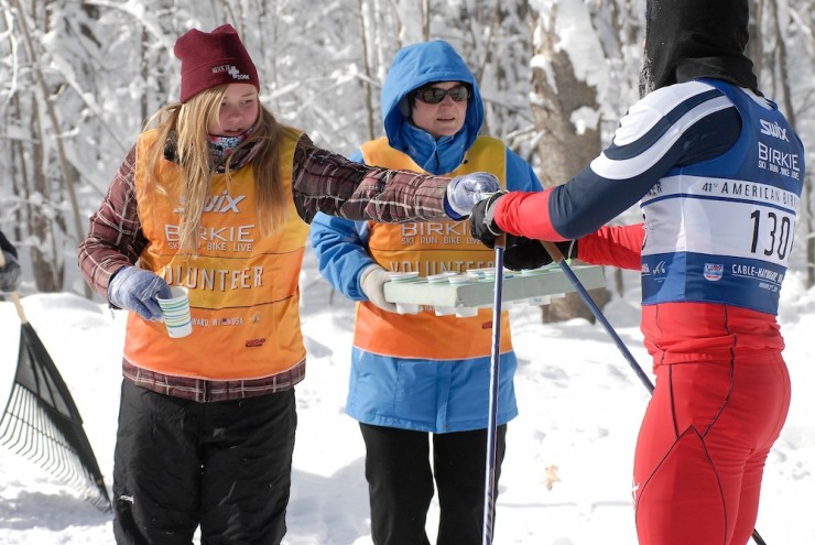 Birkie volunteers assist a racer during the 2014 American Birkebeiner from Cable to Hayward, Wis. (Photo: ABSF/Brett Morgan)