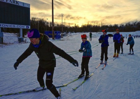 Caitlin Patterson (Craftsbury GRP) pulls a train of happy skiers at the mushing station  at the fourth-annual Lickety-Splits Ski Camp for Kids on Dec. 22 in Anchorage, Alaska. (Photo: Lickety-Splits)