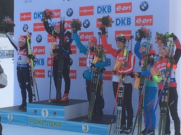 The podium and flower ceremony, with Gabriela Soukalova of the Czech Republic standing on the top step after winning her first World Cup of the season, and Canada's Rosanna Crawford (3rd from right) in fourth place. Photo: Tom Zidek.