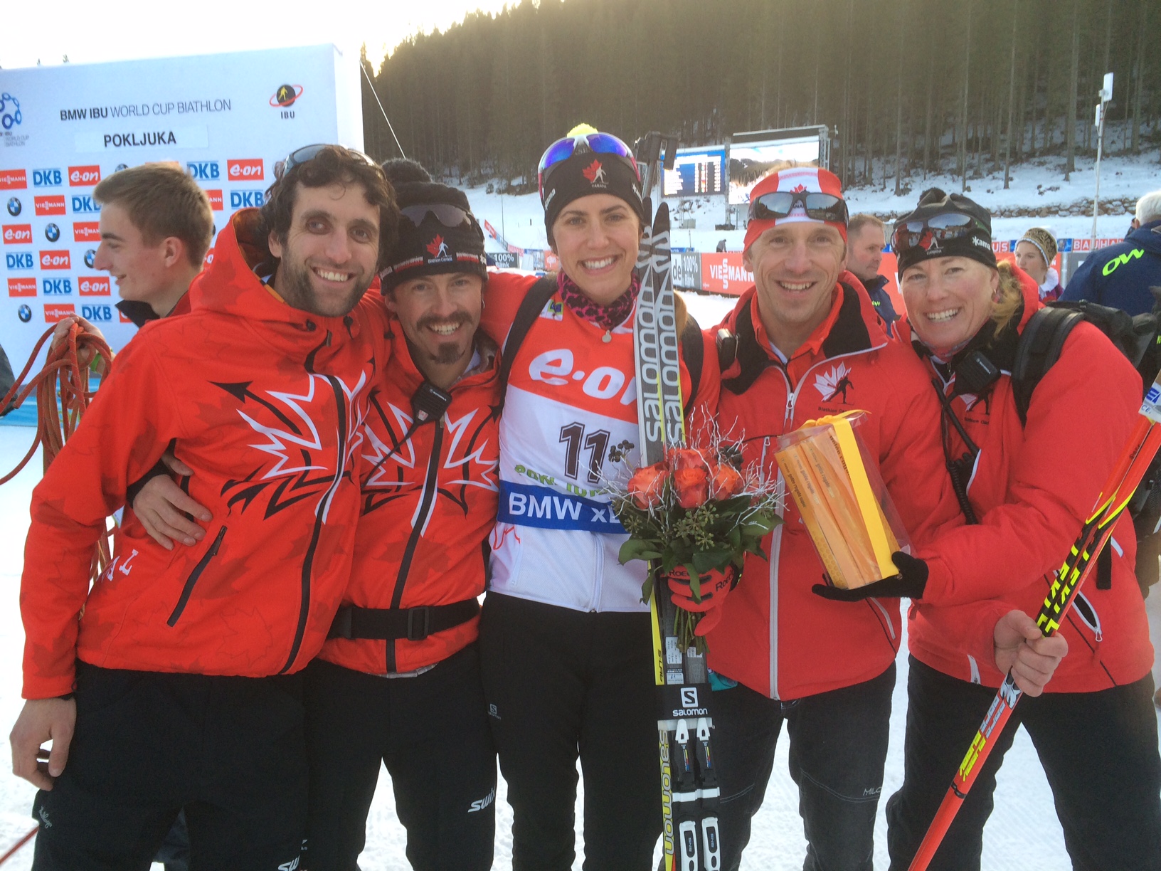 Canada's Rosanna Crawford (center) after finishing fourth in today's World Cup sprint with, l-r, ski technicians Raphael Grosset, Tom Zidek, and Pavel Stolba, and physio Yvonne Visser. Photo: Matthias Ahrens.