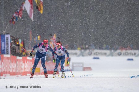 Gabriela Soukalova (l) tagging Czech teammate Jitka Landova in first in the women's 4 x 6 k relay at the Ruhpolding IBU World Cup  on Thursday in Germany. (Photo: IBU/Ernst Wukits)