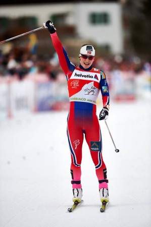 Marit Bjoergen (NOR) celebrates another 2015 Tour de Ski stage win.  (photo: Fischer / Nordic Focus)