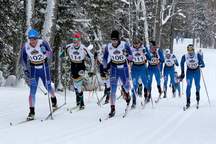 Sun Valley's Matt Gelso  (l) and Miles Havlick (r) lead the 11-man pack (with a fleet of APU and NMU skiers) around 22 k in the 30 k classic mass start at U.S. nationals in Houghton, Mich.