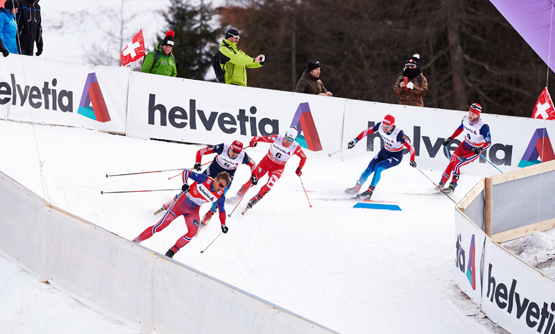 Petter Northug (NOR), Evgeniy Belov (RUS), Federico Pellegrino (ITA), Ilia Chernousov (RUS), Martin Johnsrud Sundby (NOR), (l-r) attack the tricky corner just after the highpoint during the first lap of the finals in Val Mustair, Switzerland. (photo: Fischer/Nordic Focus)
