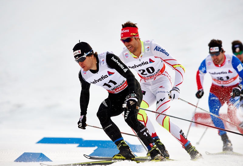 Roman Furger (SUI) is followed by Len Valjas (CAN), (l-r) in quarterfinal action in Val Mustair (SUI). (photo: Fischer/Nordic Focus)