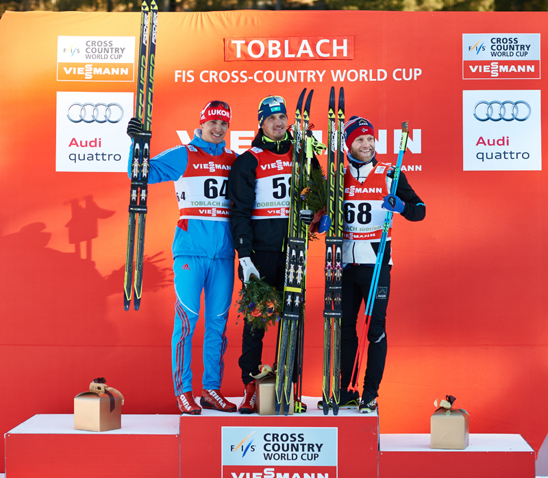 Evgeniy Belov (RUS), Alexey Poltoranin (KAZ), Martin Johnsrud Sundby (NOR), (l-r) share the top stop of the podium in Wednesday's Tour de Ski stage in Toblach, Italy.  (photo: Fischer/Nordic Focus)