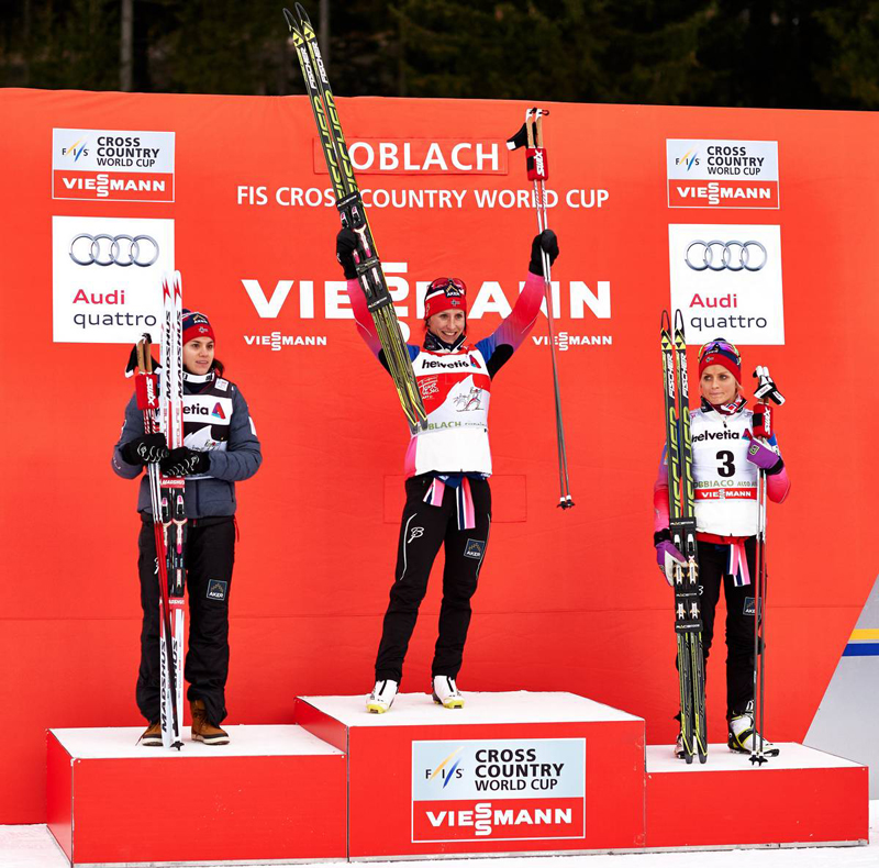 Heidi Weng (NOR), Marit Bjoergen (NOR) and Therese Johaug (NOR), (l-r) stand atop the Cortina-Toblach (ITA) Tour de Ski stage podium. (photo: Fischer / Nordic Focus)