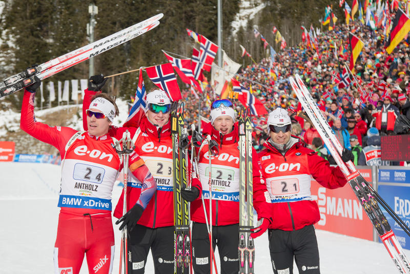 The Norwegian men including Ole Einar Bjørndalen (right) celebrate after winning the 7.5 k team relay in Antholz, Italy, in January 2015. (Photo: IBU/ChristianManzoni)