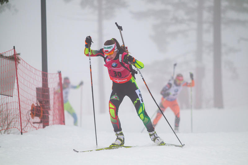 Darya Domracheva of Belarus racing though the fog to second despite one penalty in the women's 15 k individual at the IBU World Cup in Olso, Norway, in 2015. (Photo: IBU/Christian Manzoni)