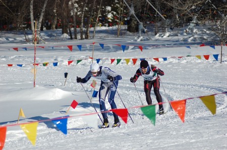 Eirik Fosnaes (UNH) and Hugo Fontaine (LAV) round a corner in the men's 10k classic at Middlebury (photo: Silke Hynes)