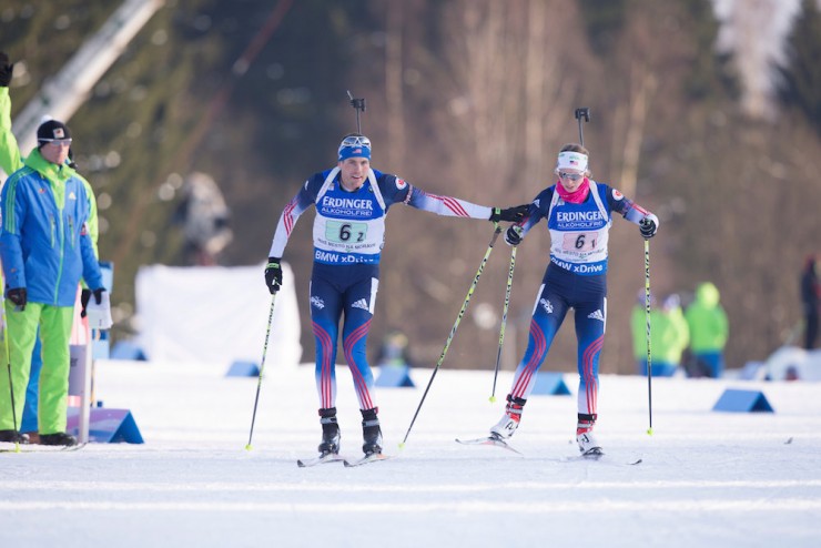 Tim Burke (l) tags U.S. teammate Annelies Cook in 15th in the second-to-last exchange in Friday's single mixed relay at the IBU World Cup in Nove Mesto, Czech Republic. The two went on to place ninth when Burke skied up from 14th on his second-and-final leg. (Photo: USBA/NordicFocus)
