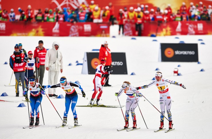 Krista Parmakoski tags Riitta-Liisa Roponen for Finland while Sweden's Stina Nilsson heads out on her last lap after being tagged by Maria Rydqvist n the 4 x 5 k relay at the 2015 FIS Nordic World Ski Championships. (Photo: Fischer/NordicFocus) 