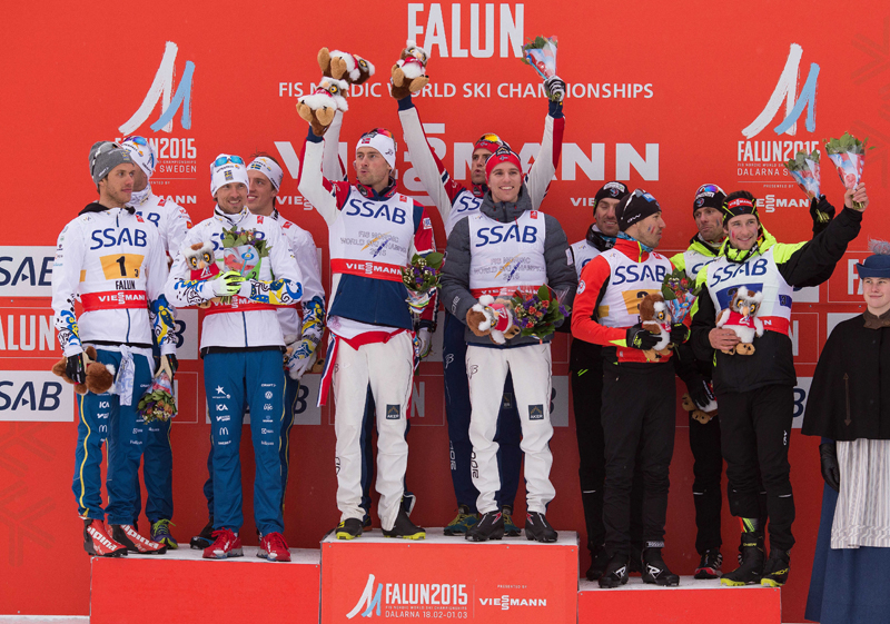 Petter Northug (front left) and Didrik Tønseth (front right) share the top step of the podium after teaming up for gold in the 4 x 10 k relay at 2015 World Championships in Falun, Sweden. (Photo: Fischer/NordicFocus)
