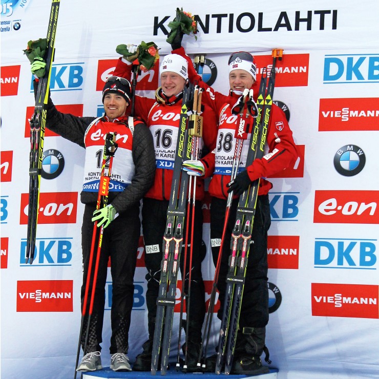 Nathan Smith (l) on the 2015 IBU World Championships 10 k sprint podium on Saturday with Norwegian brothers Johannes Thingnes Bø (c) and Tarjei Bø (r) in Kontiolahti, Finland. Smith placed second for Canada's first-ever men's podium at World Championships. 