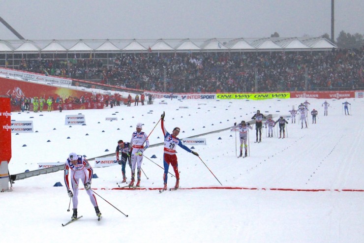 Petter Northug catches his breath after wining the 50 k classic mass start at the 2015 FIS Nordic World Championships in Falun, Sweden. Behind him, Czech skier Lukas Bauer celebrates second as Johan Olsson crosses in third and Maxim Vylegzhanin finishes fourth.  