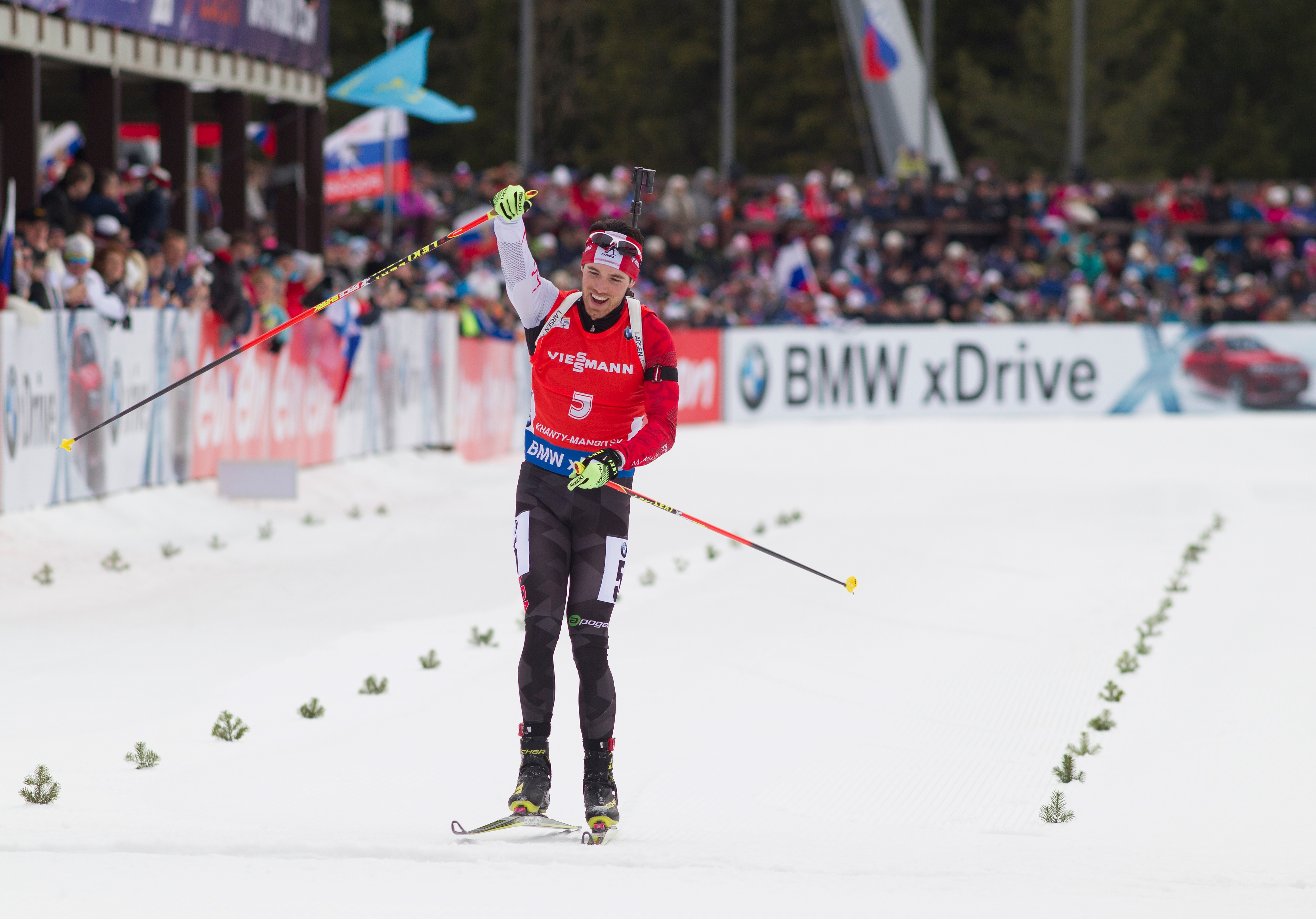 Nathan Smith of Canada celebrates as he crosses the finish line all alone after the 12.5 k pursuit in Khanty-Mansiysk, Russia, for his first career World Cup victory. (Photo: Biathlon Canada/NordicFocus.com)