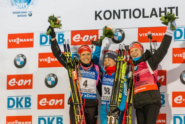 The women's 15 k individual podium at 2015 IBU World Championships, with Russian winner Ekaterina Yurlova (c), silver medalist Gabriela Soukalova (l) of the Czech Republic, and Finland's bronze medalist Kaisa Mäkäräinen (r). (Photo:  Kontiolahden Urheilijat/Kari Kuninkaanniemi) 
