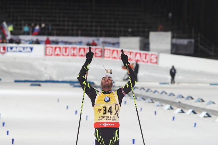 A relieved Martin Fourcade of France crosses the line in first in Thursday's 20 k individual at the 2015 IBU World Championships, 20.9 seconds faster than Norway's Emil Hegle Svendsen to win his first medal of the championships in 47:29.4 in Kontiolahti, Finland. (Photo: Kontiolahden Urheilijat/Kaisa Kontiainen)