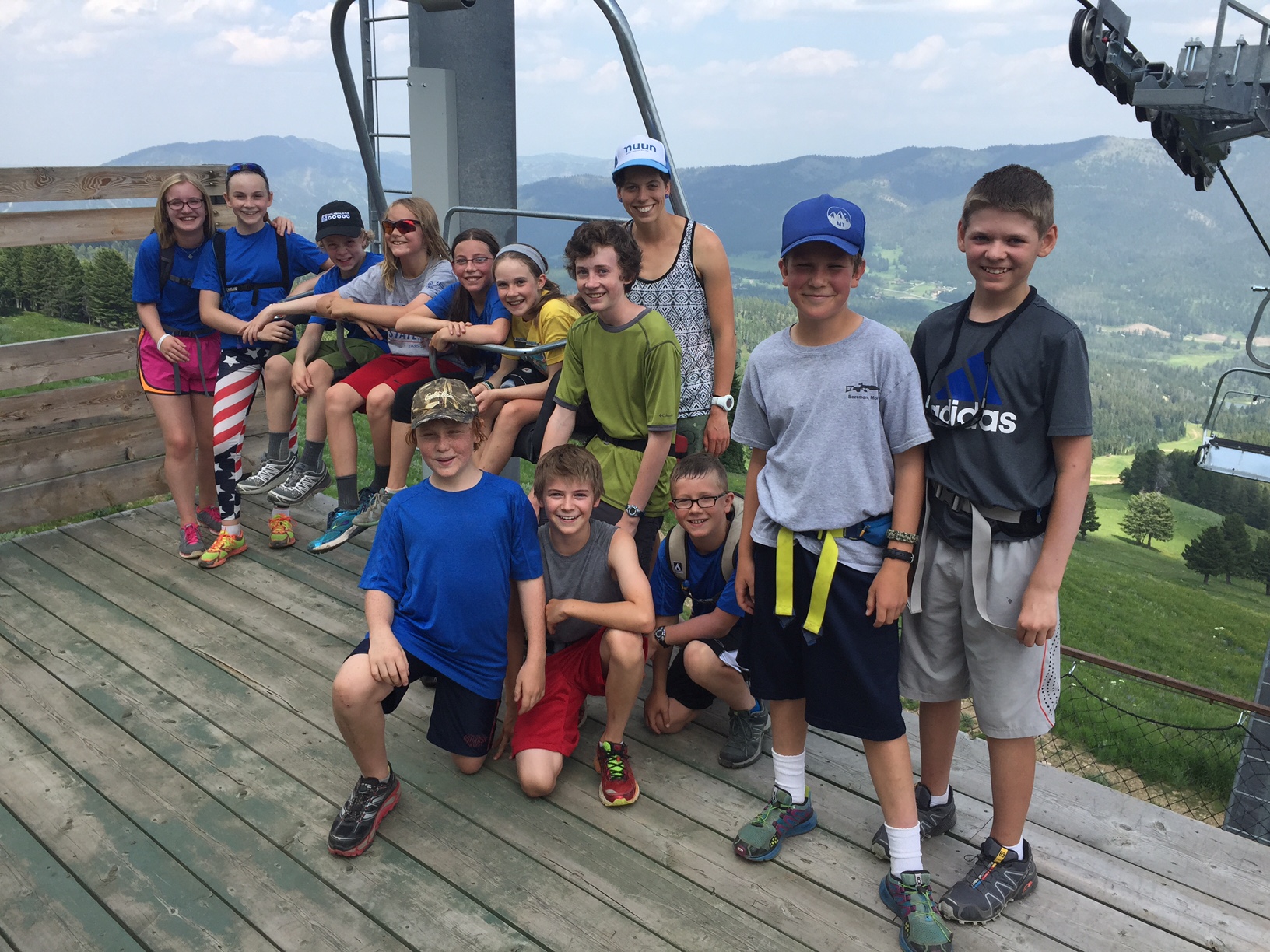 Corrine Malcolm (standing in Nuun hat) with some of her athletes after a Bridger Biathlon Club practice this summer. (Photo courtesy of Corrine Malcolm)