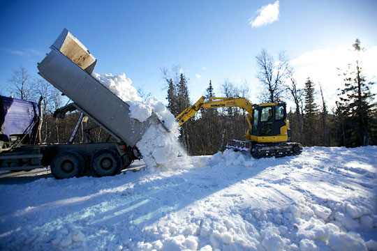 Snow saved from last season is dumped in Beitostølen, Norway. The resort opened its cross-country ski trails on schedule, but warm temperatures are jeopardizing the upcoming season-opening FIS races there in November. (Photo: NSF) 