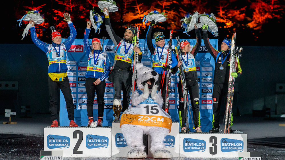 The 2015 World Team Challenge podium, with France’s Martin Fourcade and Marie Dorin-Habert (c) celebrating their victory, the Czech Republic’s Ondrej Moravec and Gabriela Soukalova in second place (left), and Germany’s Vanessa Hinz and Simon Schempp in third place (right). (Photo: Biathlon-aufSchalke.de) 