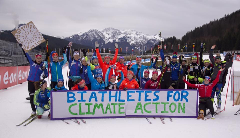 With green grass on the shooting range infield and on the side of the trail, biathletes organized by Hannah Dreissigacker and her U.S. teammates called for action at the Paris climate change conference: they hope they won't continue to see less and less snow every winter. (Photo: Manzoni, NordicFocus/ US Biathlon Women Facebook).