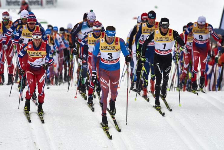 Norway's Martin Johnsrud Sundby (l) heads out in front of the 15 k classic mass start with Russia's Sergey Ustiugov (3), Switzerland's Dario Cologna (7), and fellow Norwegian Emil Iversen (r) during Stage 7 of the Tour de Ski in Val di Fiemme, Italy. Sundby went on to win ahead of teammate Niklas Dyrhaug in second and Kazakhstan's Alexey Poltoranin in third. (Photo: Fischer/NordicFocus)