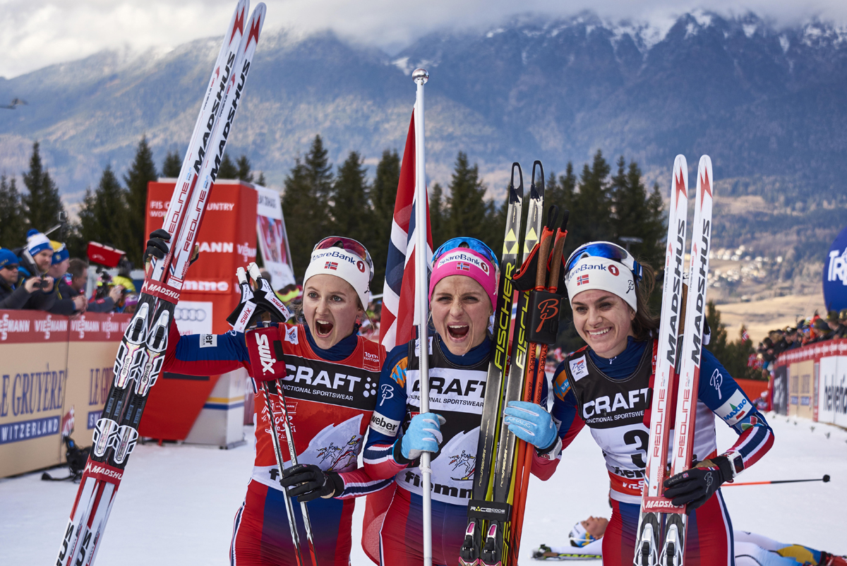 2016 Tour de Ski overall runner-up Ingvild Flugstad Østberg (l), champion Therese Johaug (c) and third-place finisher Heidi Weng (r) celebrate Norway's sweep of the podium at Sunday's Stage 8 final climb in Val di Fiemme, Italy. (Photo: Fischer/NordicFocus)