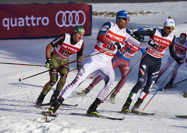 Andy Newell (in white) rounds a corner with Germany's Thomas Bing (l), Italy's Dietmar Noeckler (r) during the World Cup men's freestyle team sprint final in Planica, Slovenia. 