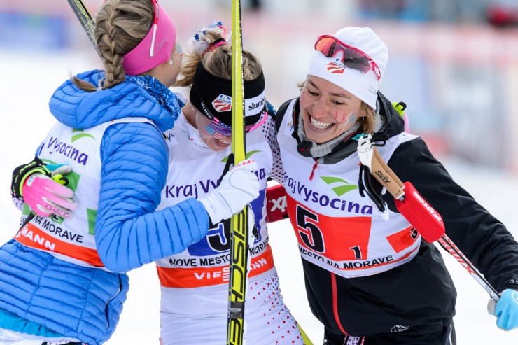Jessie Diggins (c) celebrates with teammates Sadie Bjornsen (l), Sophie Caldwell (r) and Liz Stephen (not shown) after anchoring the U.S. women's 4 x 5 k relay to a best-ever second in the Nove Mesto World Cup on Sunday in the Czech Republic. (Photo: Fischer/NordicFocus)