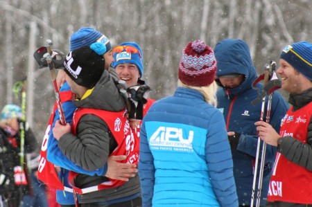 APU coaches and wax techs celebrate with hugs after having three APU athletes in the top four, including overall race winner Eric Packer (not shown) for the men's 1.5 k classic sprint on Saturday at U.S. nationals in Houghton Mich. 