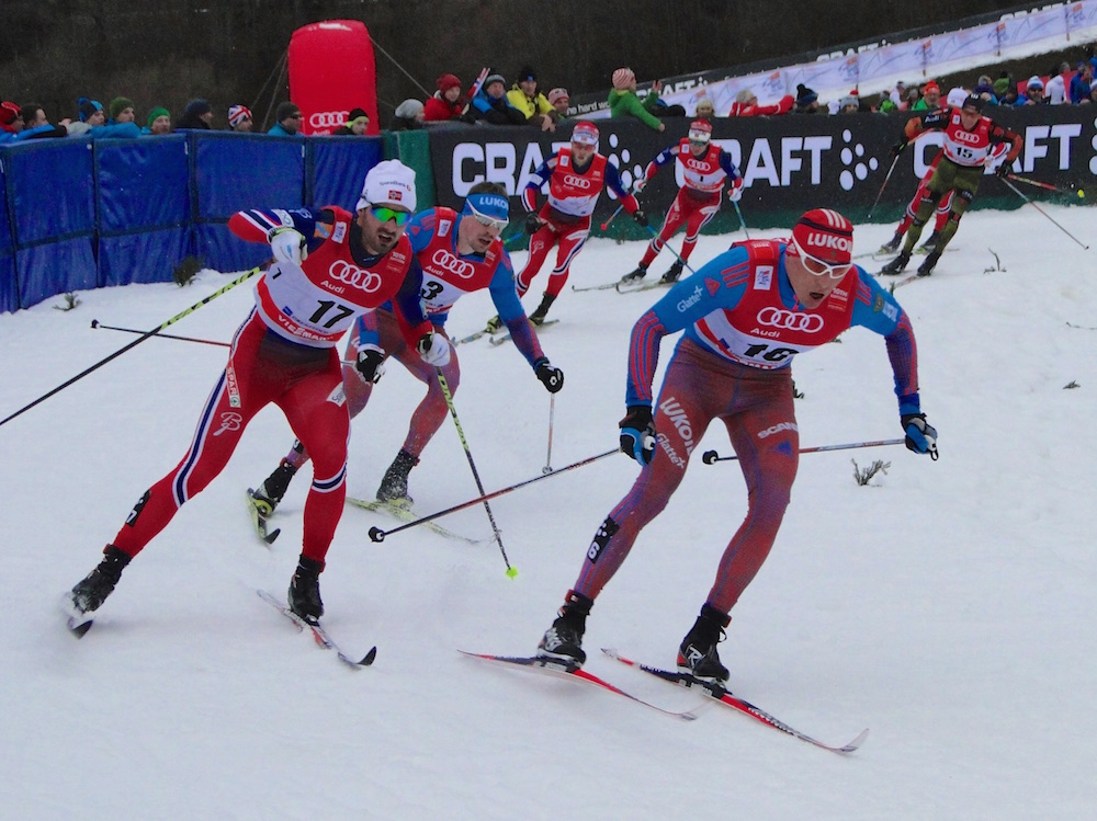 Alexander Legkov of Russia leads Martin Johnsrud Sundby of Norway and Sergey Ustiugov of Russia in the 15 k classic mass start stage of the 2016 Tour de Ski in Oberstdorf, Germany. (Photo: Harald Zimmer)