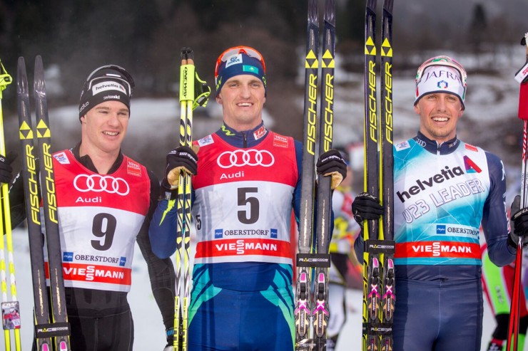 The men's 15 k classic mass start podium at Stage 5 of the Tour de Ski in Oberstdorf, Germany: (from left to right) Swiss runner-up Dario Cologna, winner Alexey Poltoranin (Kazakhstan), and Francesco de Fabiani (Italy) in third. (Photo: Marcel Hilger)