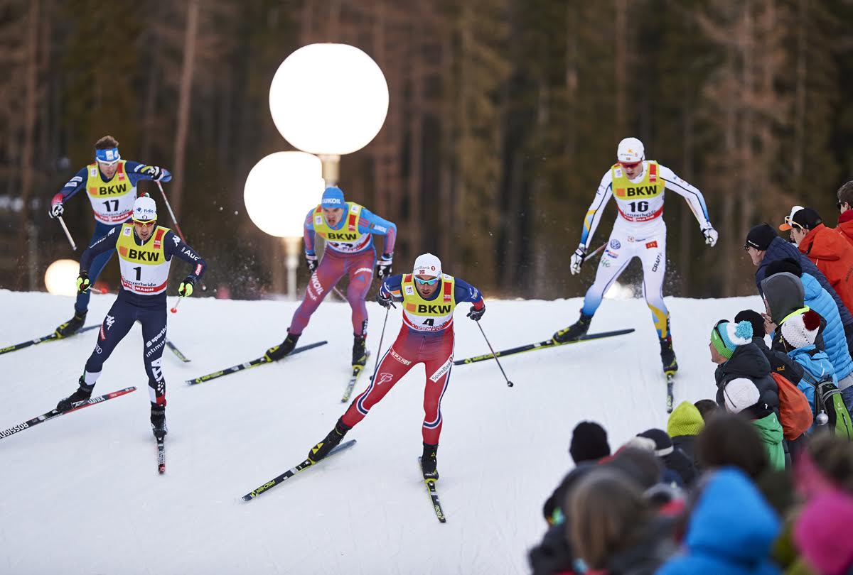 The second men's quarterfinal, with Italy's Federico Pellegrino (1) and Norway's Petter Northug (4) leading, followed by American Andy Newell (17), Russia's Andrey Larkov (c) and Sweden's Oskar Svensson (r) at the Tour de Ski freestyle sprint in Lenzerheide, Switzerland. (Photo: Fischer/NordicFocus)