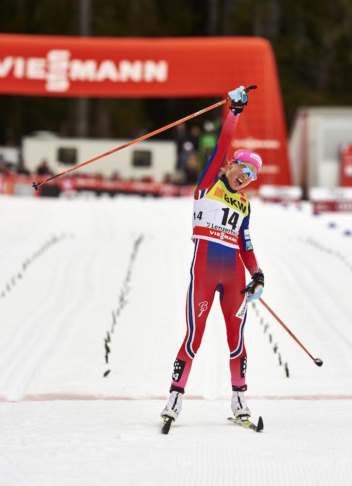Norway's Therese Johaug celebrates at the finish of Saturday's 15 k classic mass start in Lenzerheide, Switzerland. She won the race by nearly 38 seconds to take the lead in the Tour de Ski after the second stage. (Photo: Fischer/NordicFocus)