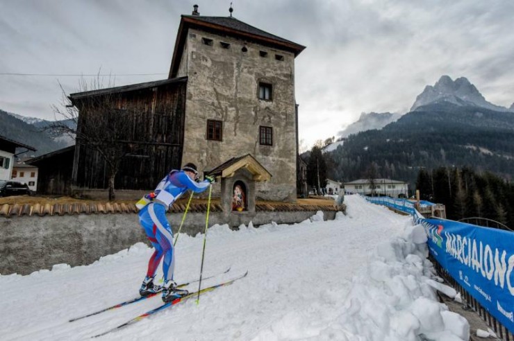 A skier climbing through one of the many towns dotting the Marcialonga course in the Dolomites of Northern Italy 