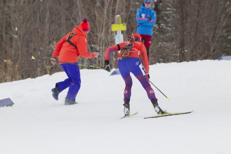 A US Biathlon staff member (l) cheers on Susan Dunklee (r) as she races to a career-best second place in the 7.5 k sprint on Thursday at the IBU World Cup in Presque Isle, Maine. (Photo: Fischer/NordicFocus)