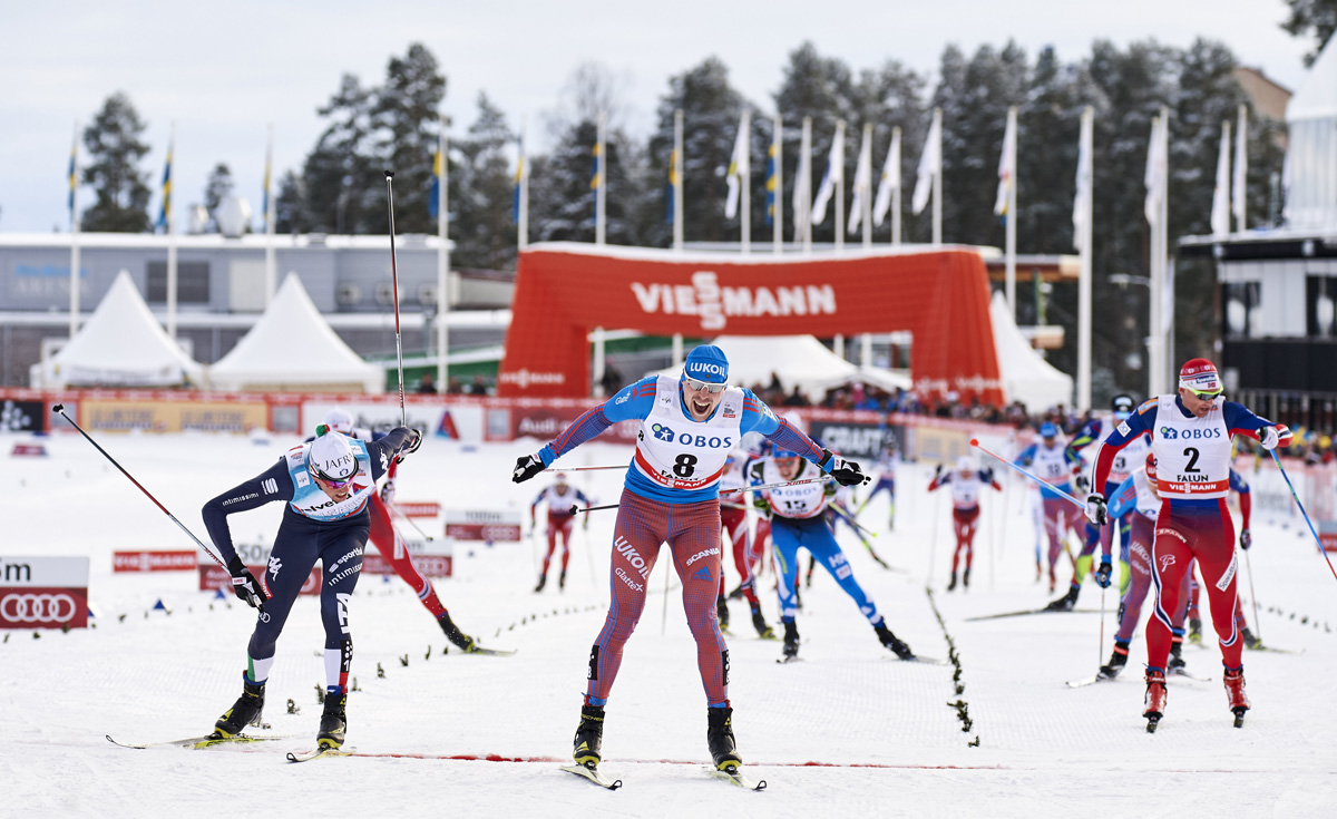Russian Sergey Ustiugov (center) takes the win ahead of Italy's Francesco De Fabiani (l) and Norwegian Niklas Dyrhaug (r) during the men's 15 k freestyle mass start on Sunday in Falun, Sweden. (Photo: Fischer/NordicFocus)