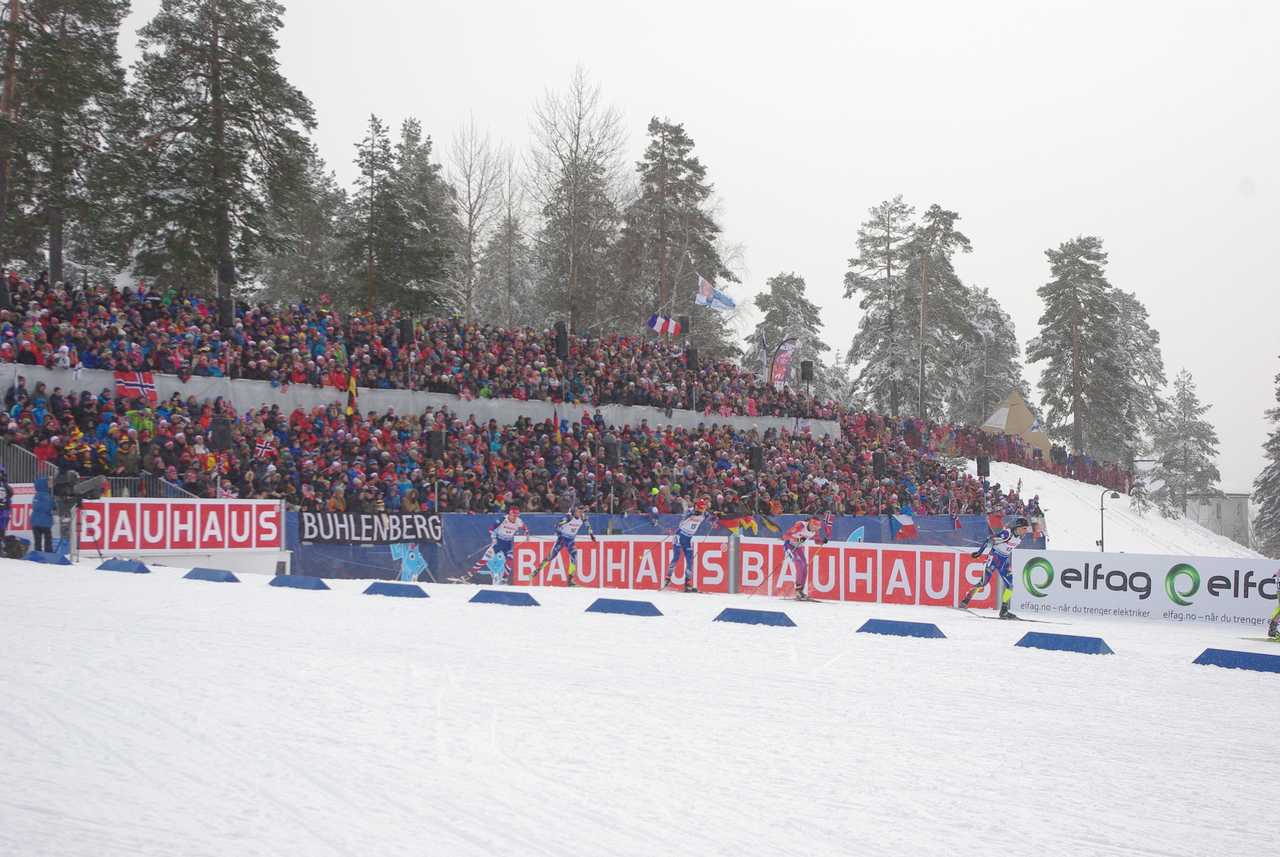Tim Burke of the United States (second skier from right) entering the stadium.