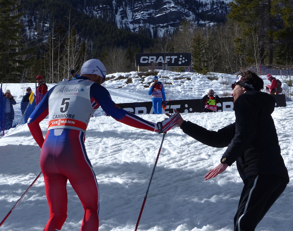 Petter Northug (NOR) (l) high fives Remi Drolet (spectator) as he finishes his final lap during the men's 1.5 k classic sprint at the Ski Tour Canada on Tuesday in Canmore. (Photo: Peggy Hung)