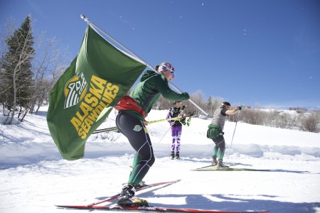 University of Alaska Anchorage skier Casey Wright carries the team flag of the Seawolves at the 2016 NCAA Skiing Championships last March at Howelsen Hill in Steamboat Springs, Colo. (Photo: Jamie Schwaberow/NCAA Photos)