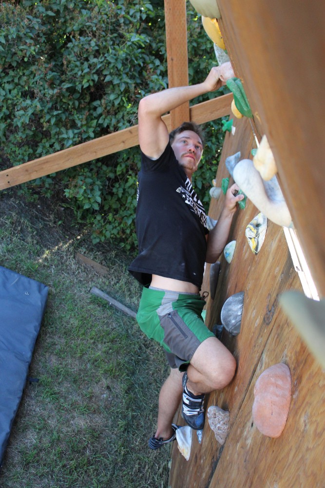 Jason Brendan traversing the backyard climbing wall in Bozeman, Mont.