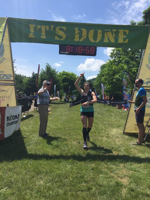 Corrine Malcolm (center) raises one hand in victory as she crosses the finish line in first for the Cayuga Trails 50 mile race in Ithaca New York this past May. (Photo: corrinemalcolm.com)