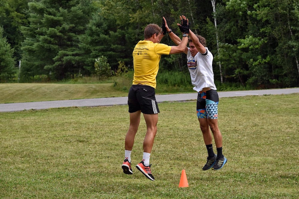 Paul Schommer (l) and Jake Brown doing high-five partner burpees during a strength workout at the U.S. Biathlon development camp in Jericho, Vermont. (Photo: Katrina Howe)