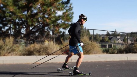 Dave Cieslowski uses a therapy band above his knees to help cues the glutes to fire while skate/roller skiing. 